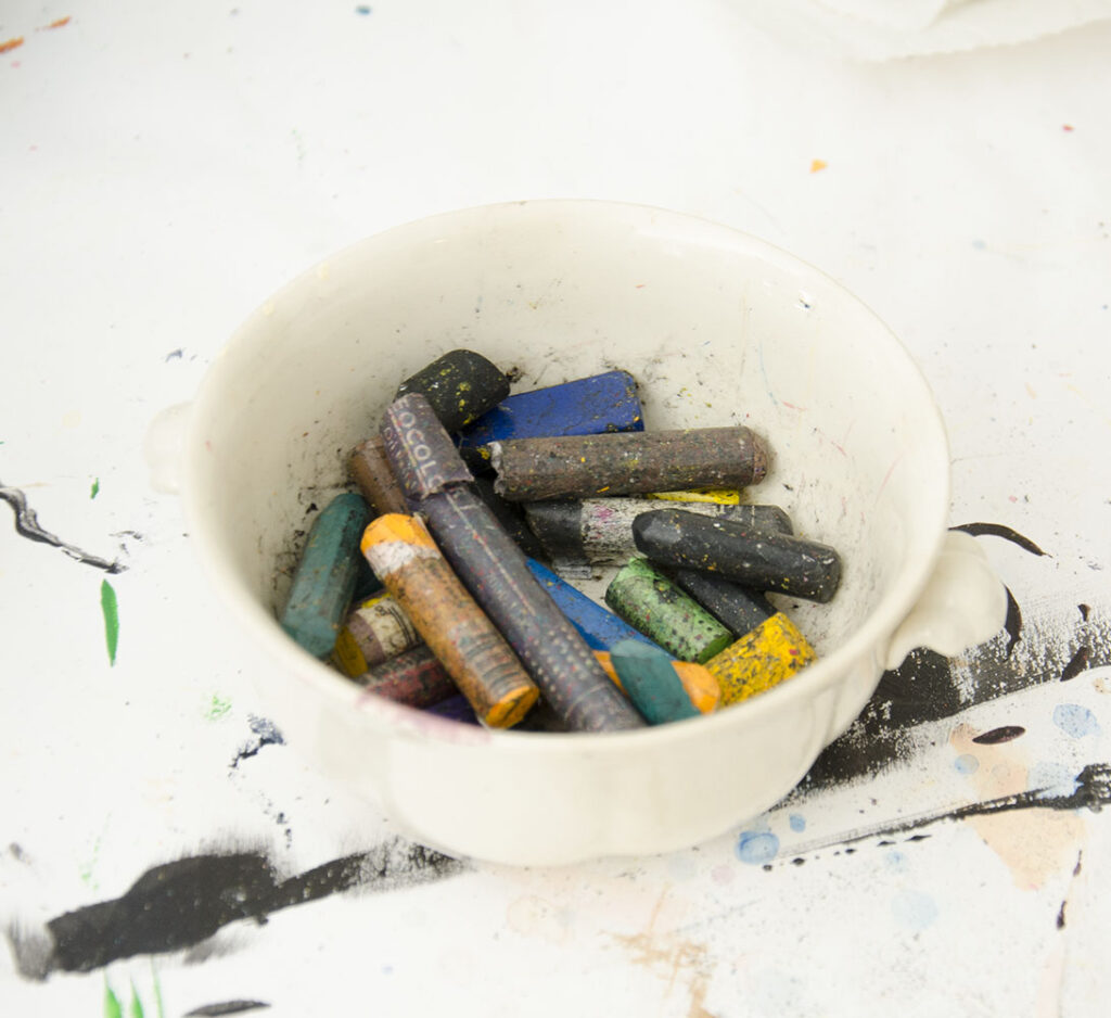 A jar with different colored crayons